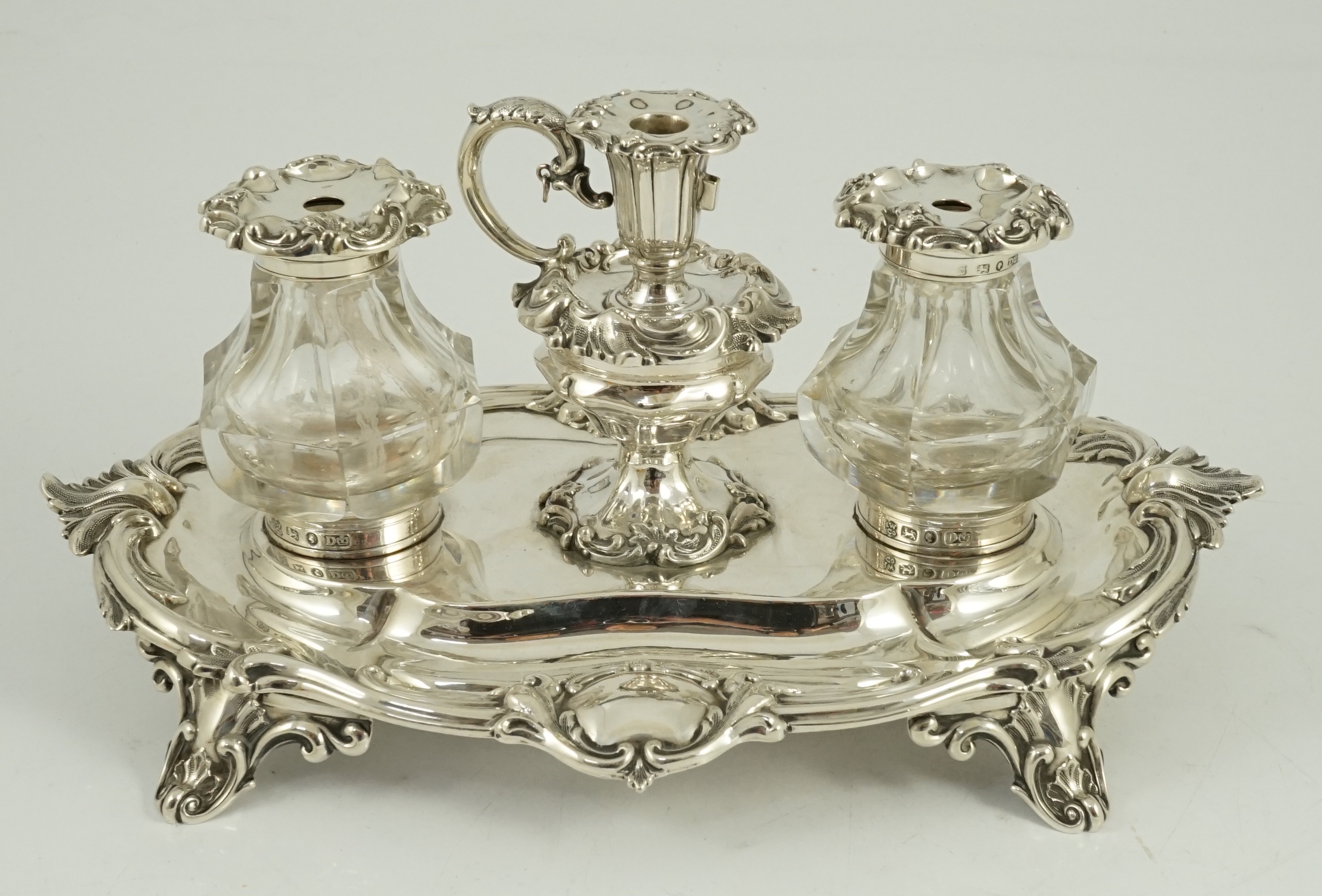 An ornate Victorian silver oval inkstand, by Henry Wilkinson & Co
